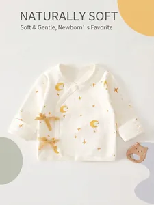 Detailed view of soft cotton newborn kimono top featuring moon and star print designs