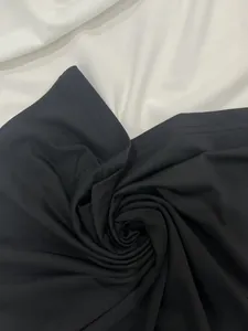 Close-up macro detail of soft black fabric texture for elegant slim fit formal dress