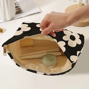 Elegant black and white floral corduroy makeup bag with hand-drawn daisy design