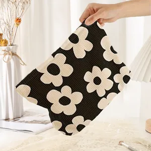 Handheld corduroy cosmetic bag with black and white floral print for travel storage