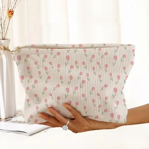 Detailed texture of tulip print corduroy makeup storage bag with a secure zipper