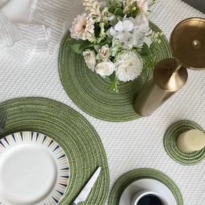 Nordic style green braided round placemats and coasters set for elegant dining table