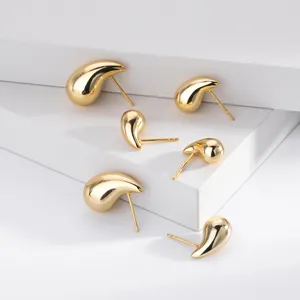 Macro detail of minimalist gold-plated S925 sterling silver teardrop stud earrings