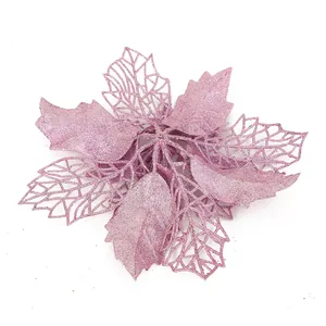 Close-up detail of a pink glitter poinsettia flower used for festive Christmas decorations.