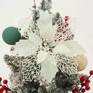 Close-up of white glitter poinsettia Christmas flower decoration with hollow leaves