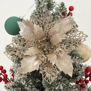 Glittering gold poinsettia flower ornament for festive Christmas tree decoration detail