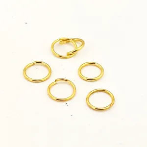 Detailed macro view of electroplated gold-colored open jump rings for jewelry making