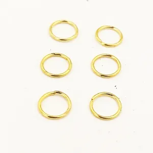 Detail view of six golden electroplated pure copper open jump rings for DIY jewelry craft