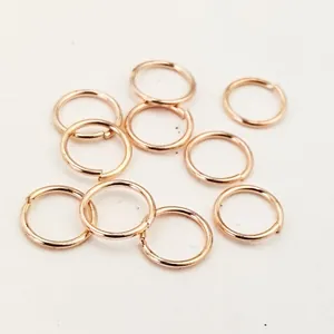 Macro view of rose gold plated open jump rings for DIY jewelry making.
