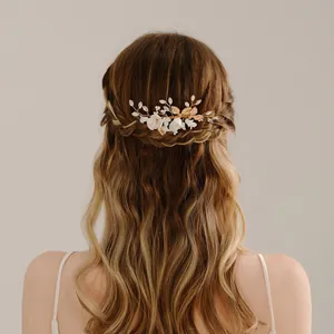 Elegant handmade bridal hair comb with white soft clay flowers and golden leaves
