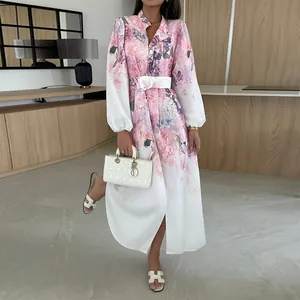 Elegant pink floral long sleeve shirt dress with lapel and white waist belt.