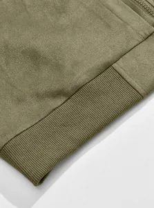 Macro detail shot showing army green suede knit fabric and ribbed hem of a men's jacket