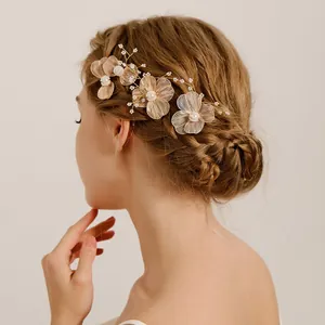 Elegant handmade bridal headpiece with crystal flowers and pearls for wedding hairstyles.