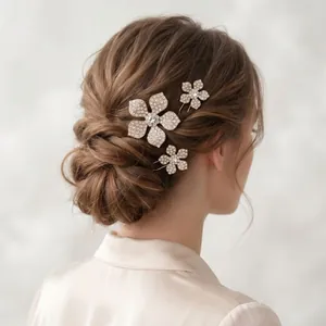 Close-up of three crystal flower hair pins styled in an elegant bridal hair updo