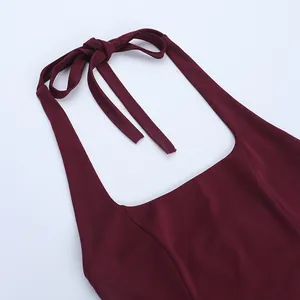 Close-up of elegant burgundy halter-neck top featuring adjustable bow-tie and square neckline