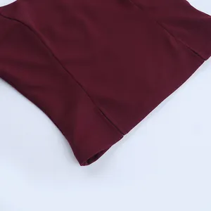 Close-up of neat stitching and hem on a burgundy slim-fit halter camisole.