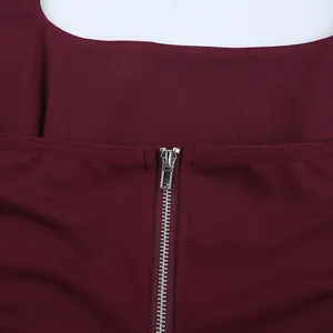 Close-up of the durable metal zipper detail on a burgundy ribbed halter neck top.