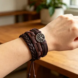 Detailed view of multilayer brown leather bracelet with tree of life charm on wrist