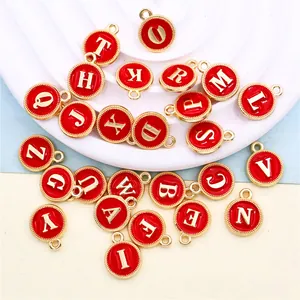 Detailed view of 26 red enamel gold alloy alphabet letter charms for DIY jewelry making