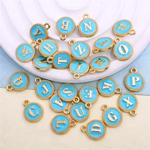 Close-up of 26 light blue enamel alphabet charms for DIY jewelry making