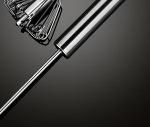 Close-up of brushed stainless steel handle and mechanism of a semi-automatic whisk.