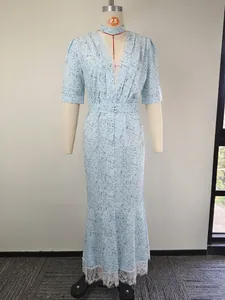 Detailed view of elegant light blue floral print V-neck dress with lace hem