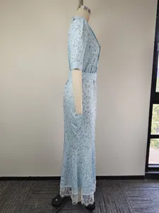 Side view of light blue floral dress showing delicate white lace hem stitching detail