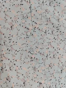 Detail of light blue floral print dress fabric with matching fabric-covered buttons