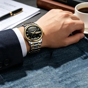 Elegant men's two-tone steel watch with black dial and double date display on wrist