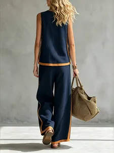 Back view of navy blue sleeveless top and wide-leg trousers set with tan trim