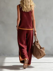Back view of burgundy sleeveless top and wide-leg trousers set with tan trim detail
