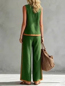 Back view of a stylish green sleeveless top and wide-leg trousers set with brown trim