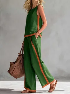 Side view of green sleeveless top and wide-leg pants set with orange contrast stripes
