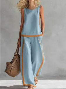 Detail view of light blue linen sleeveless top and wide-leg pants set with orange trim