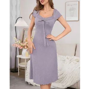 Lavender lace-trimmed short-sleeved nightgown with a bow detail in lifestyle setting.