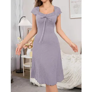 Elegant lavender midi dress with lace trim and bow detail in a cozy home bedroom setting