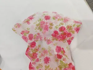Gros plan sur l'imprimé floral rose délicat et les coutures d'une robe de style rétro