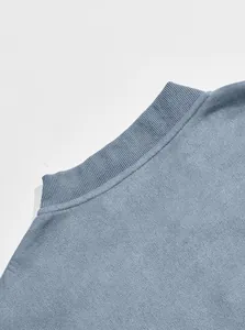Close-up detail of the ribbed standing collar on a dusty blue suede men's jacket