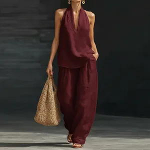 Elegant wine red two-piece halter top and wide-leg trousers set in linen-like fabric
