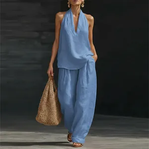 Detailed view of women's blue linen-style halter top and wide-leg trousers set.