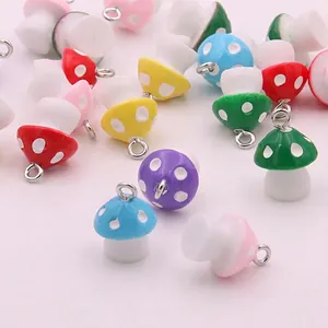 Detailed view of colorful resin mushroom charms with white polka dots for DIY jewelry making