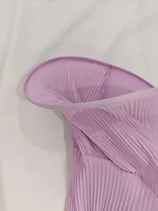 Detailed macro shot of lavender pleated fabric featuring a delicate ruffle edge finish