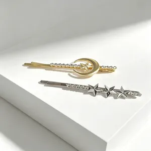 Elegant gold and silver rhinestone hair clips featuring moon and star celestial designs.