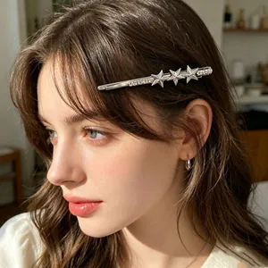 Close-up of a silver star rhinestone hair clip worn by a model in soft light