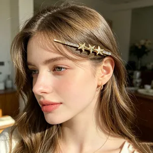 Close-up view of a star rhinestone hair clip worn by a model in warm sunlight.