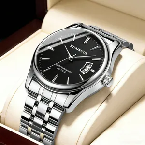 Close-up of KINGNUOS silver steel watch with black dial and date window on cushion.
