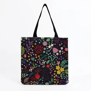 Close-up detail of a vibrant botanical floral print on a large canvas tote shopping bag