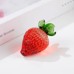Close-up of a crystal strawberry ornament with realistic red and green glass textures
