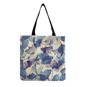 Detail view of canvas tote bag with elegant blue ginkgo leaf pattern and texture