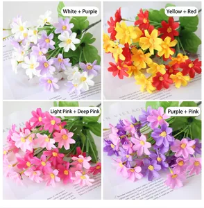 Detailed view of four color variants of artificial daisy bouquets for home decoration.